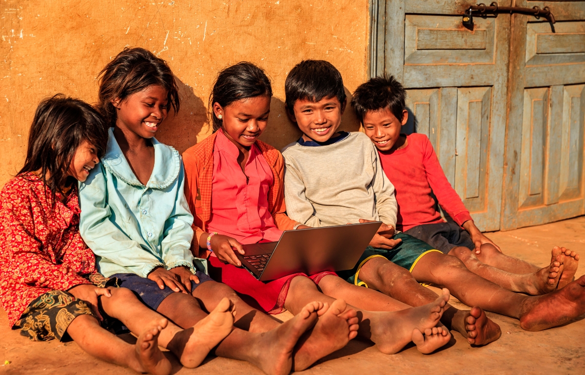 Digital Literacy in India showing NGO teaching rural students using mobile and computer